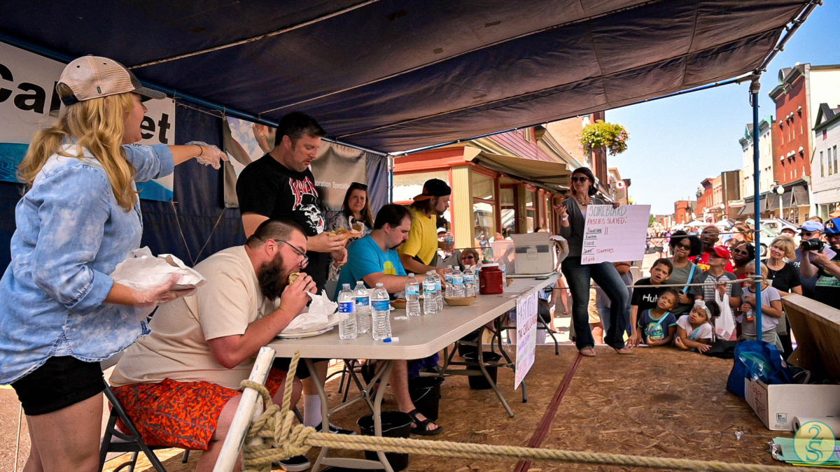 People participate in the pasty eating contest during Pasty Festival in Calumet, MI.