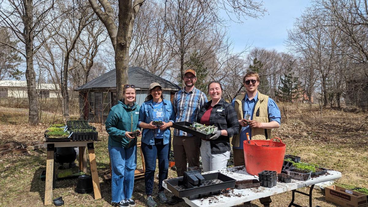 Visit Keweenaw staff takes a photo at the Keweenaw Land Trust native plant event.