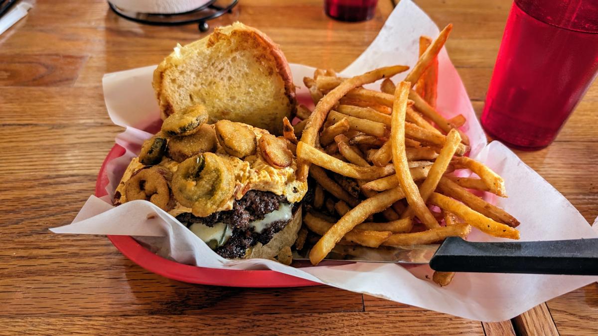 A burger and fries in a basket from Meat.