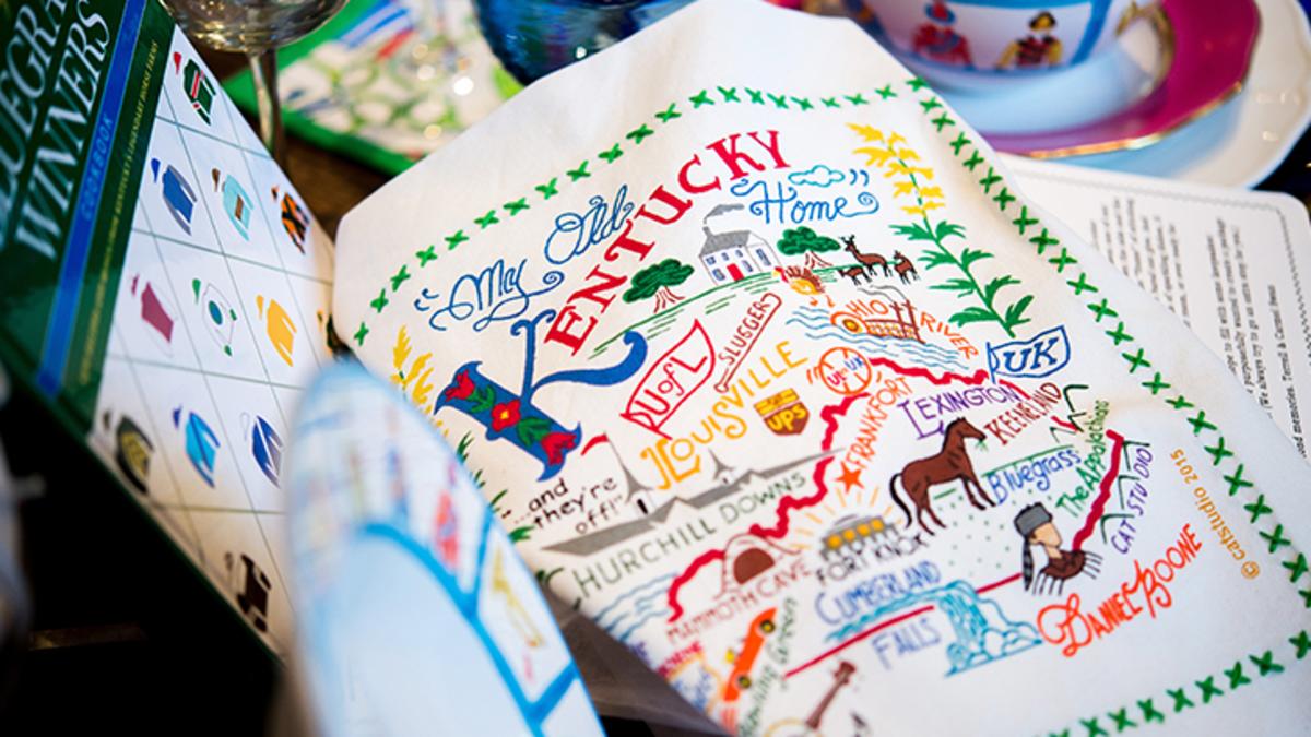 Close up of a stylized "My Old Kentucky Home" print. It is hand lettered and illustrated and includes many famous places and features in Kentucky.