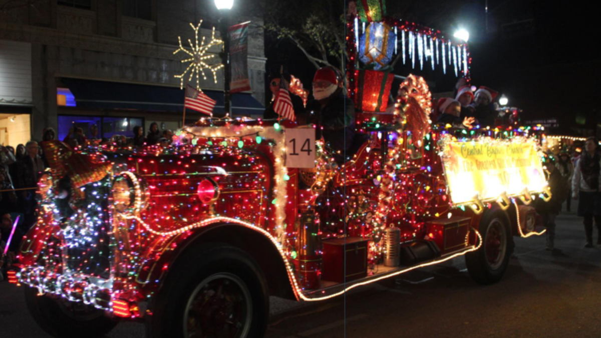 Old historic firetruck decorated in Christmas lights