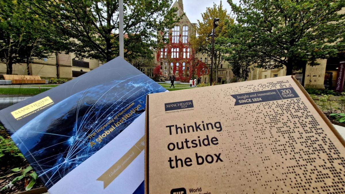 Conference brochures with a university in the background