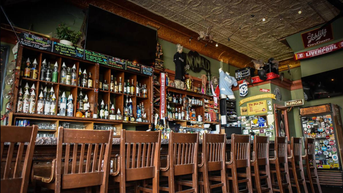 wood bar, bottles lining shelves