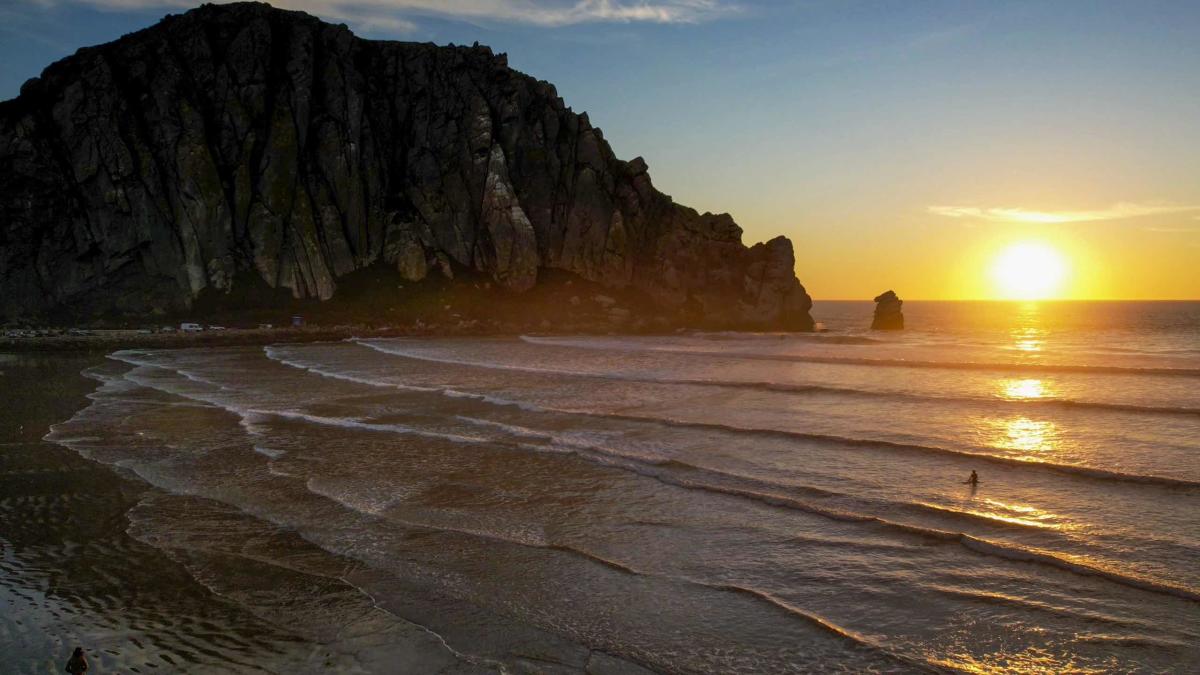 A surfer at Morro Rock Beach