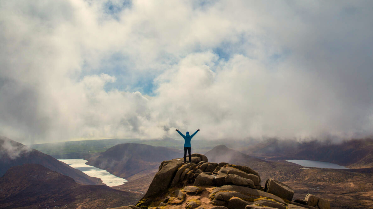 A happy hiker enjoys the view in Silent Valley