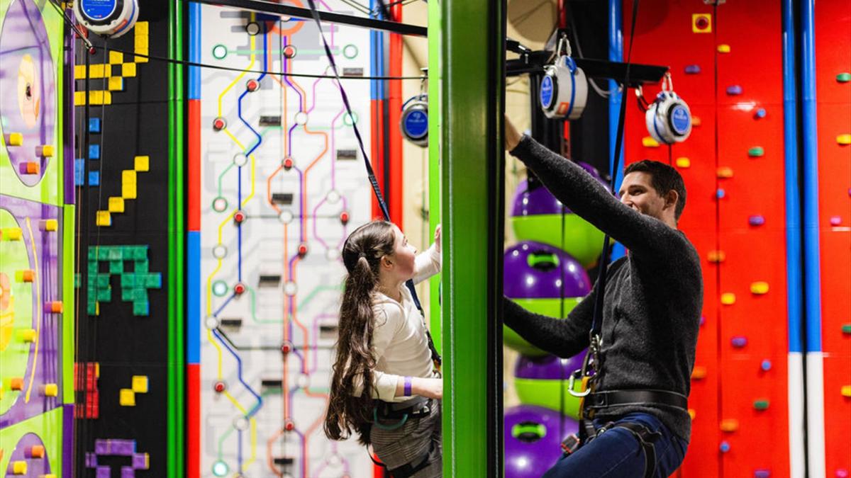 Young girl and dad on Face to Face Climbing Wall