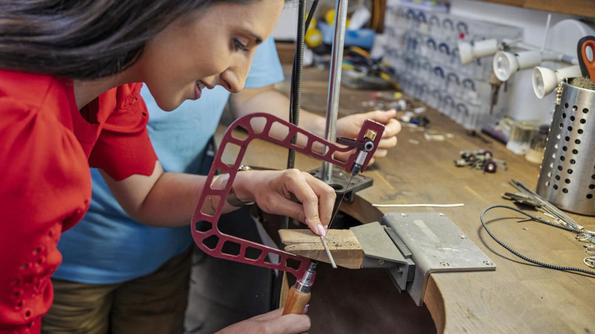 Woman cuts her piece of silver to size to make her own ring with NI silver