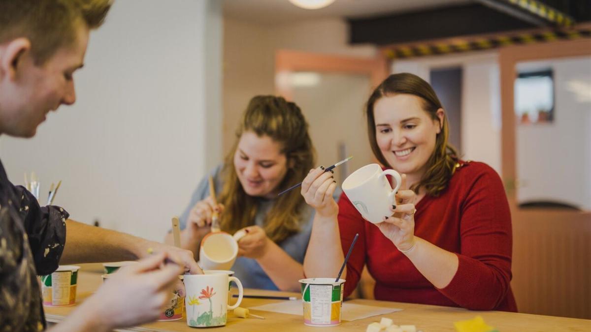 People enjoying painting pottery