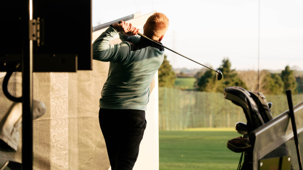 A man playing golf at Laganview Driving Range