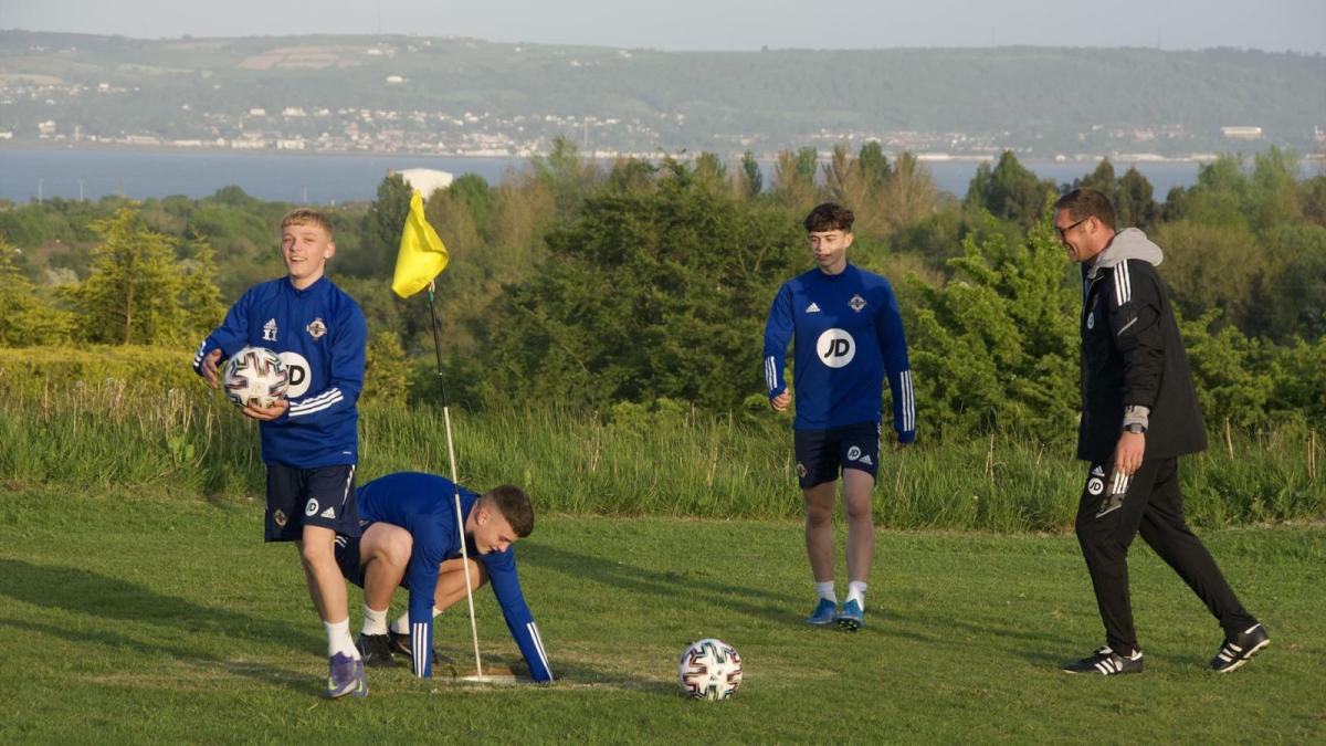 A group of boys enjoy some footgolf