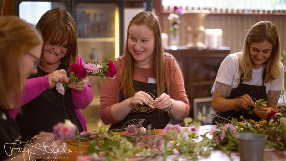 Visitors with flowers, enjoying creating at Victoriana Flower School