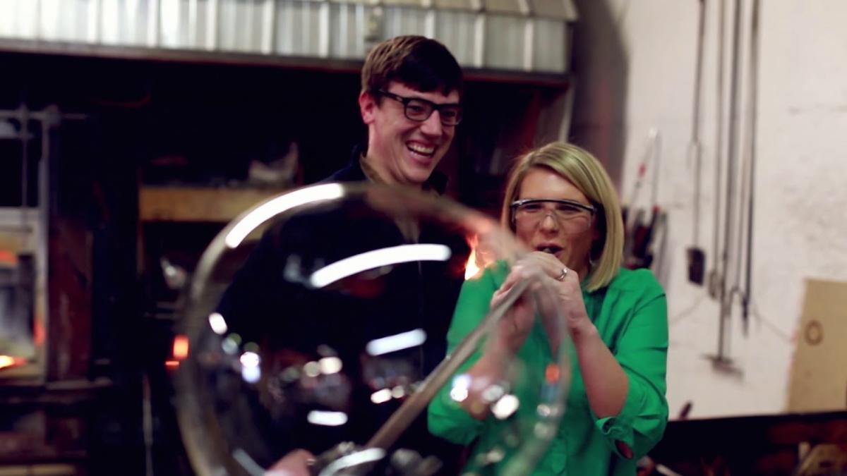 Couple blowing glass