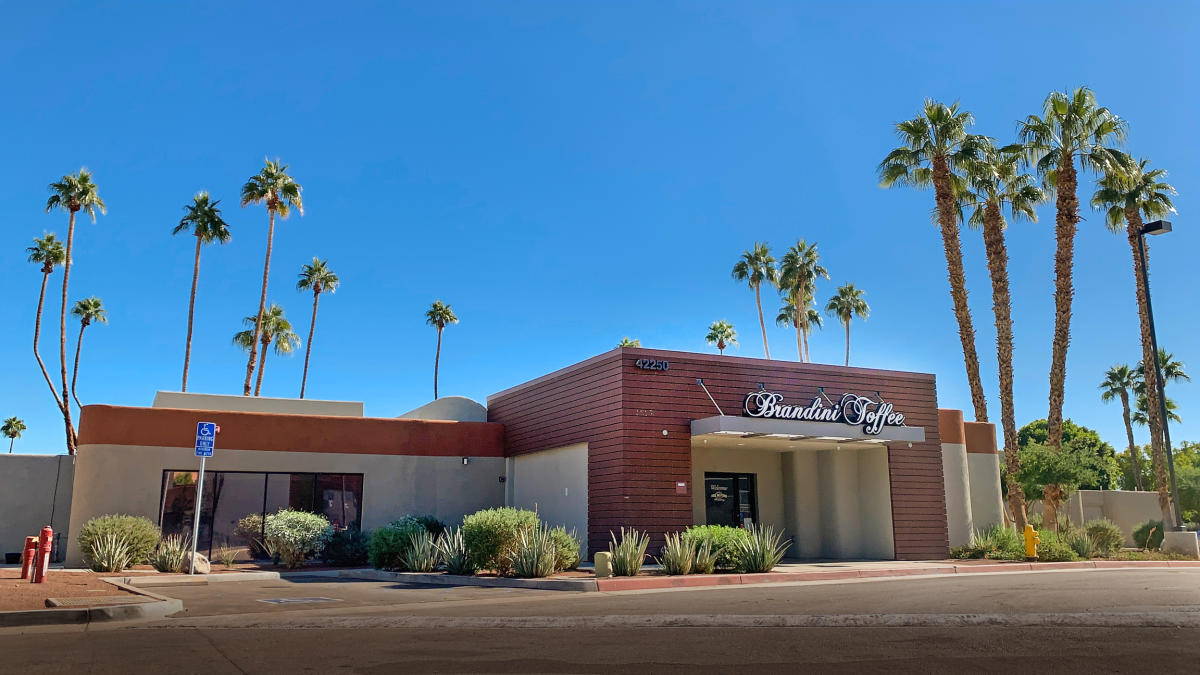Blue sky and palm trees surround Brandini Toffee in Rancho Mirage