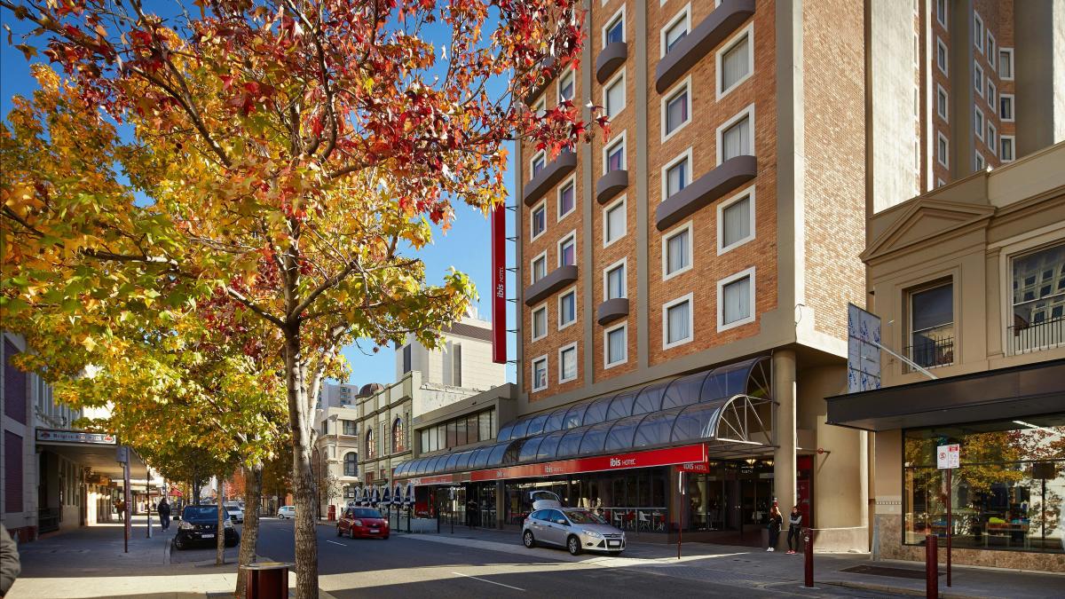 image of autumn tree and brick hotel building
