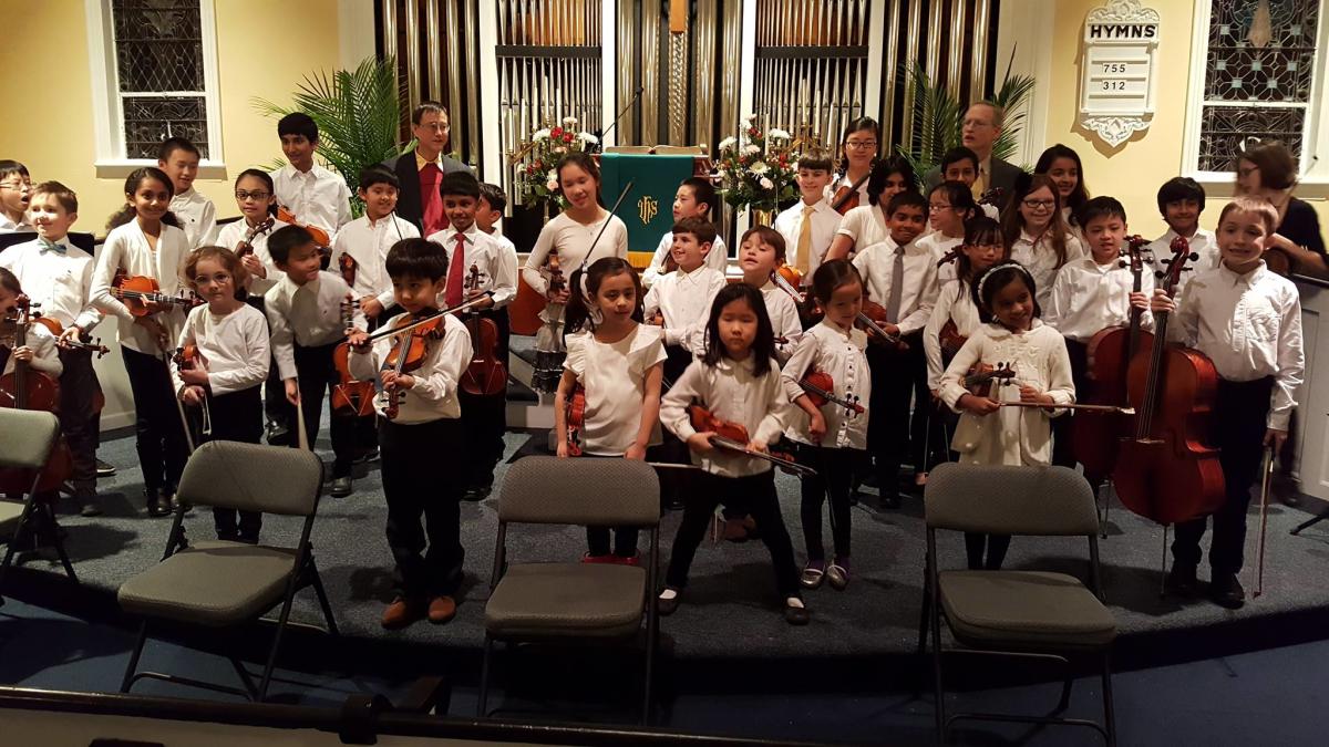 Princeton String Academy child musicians holding instruments