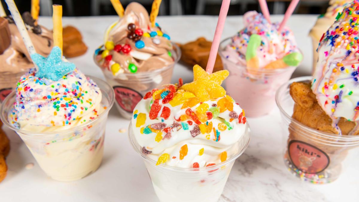 cups of a variety of flavors of ice cream decorated with sprinkles and candies