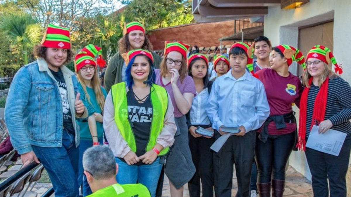 Group of volunteers in elf hats smiling