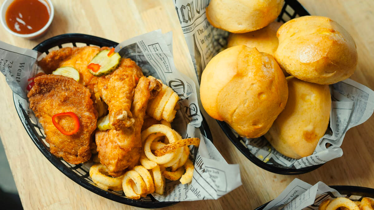 Overhead view of chicken basket and biscuit rolls