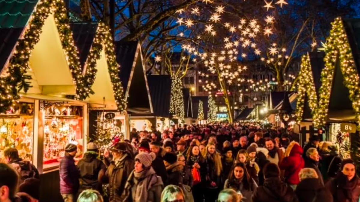 Crowd walking through holiday lights