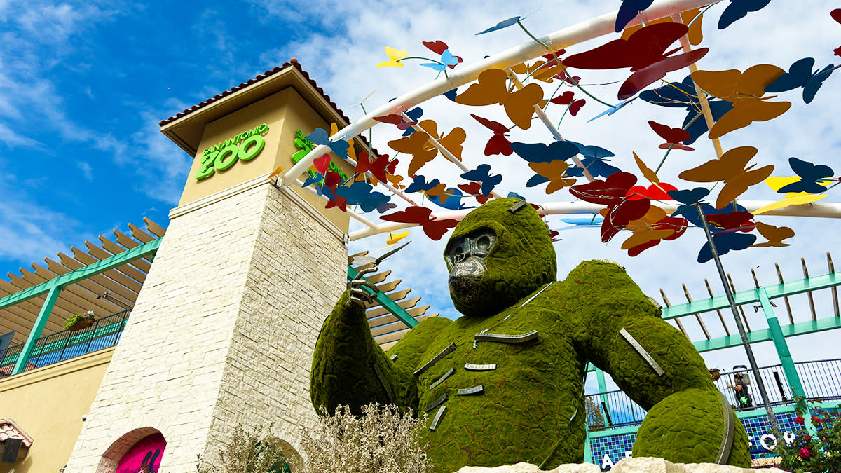 Exterior of zoo with topiary in the shape of an ape