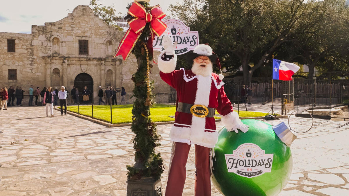 Santa standing in front of the Alamo