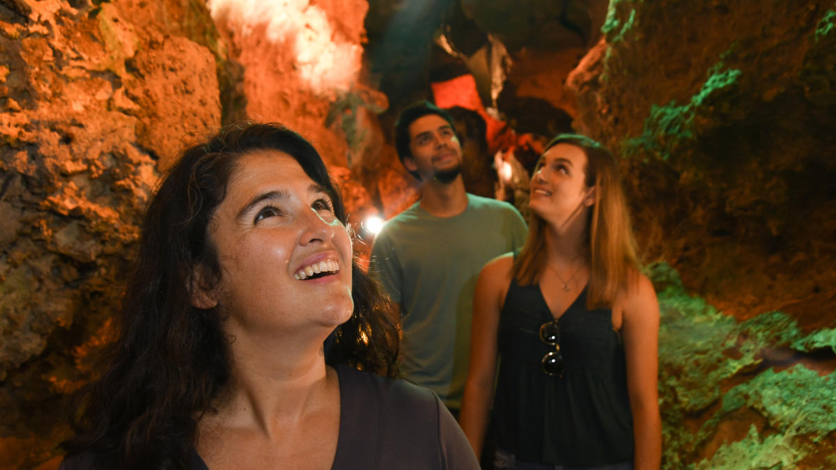 Group of three exploring cave