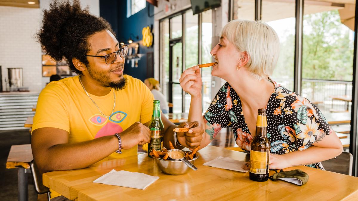 Couple sharing fries at downtown restaurant