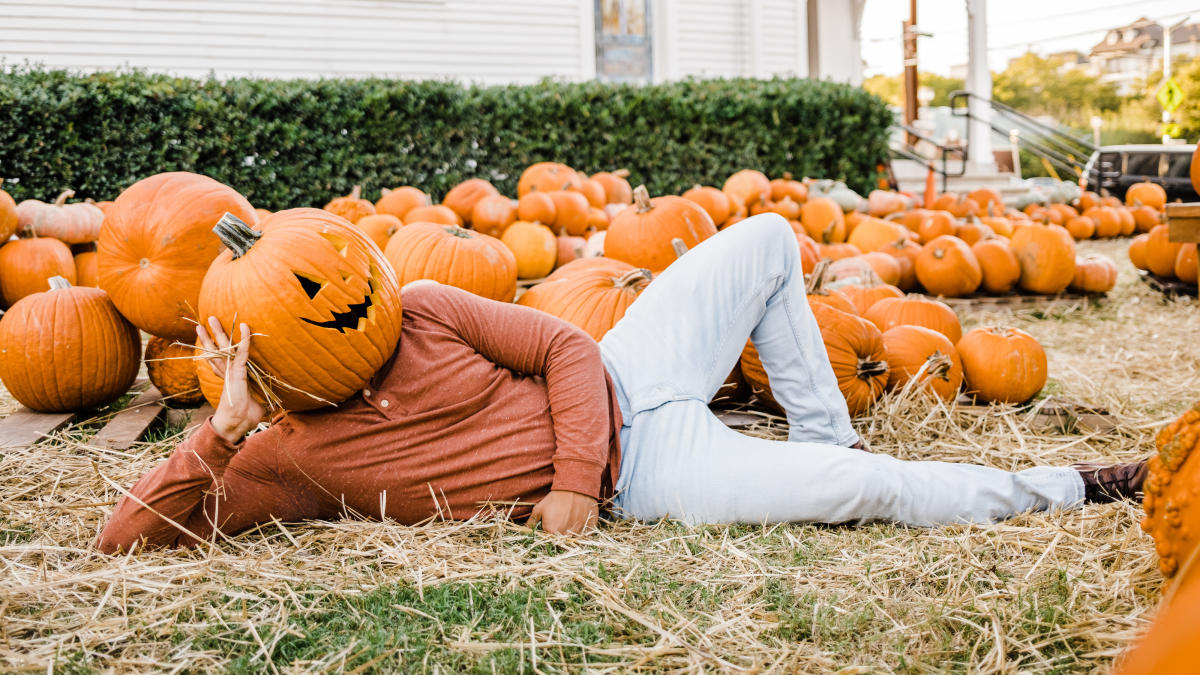 Man with funny pumpkin mask at the pumpkin patch in Downtown San Marcos, TX