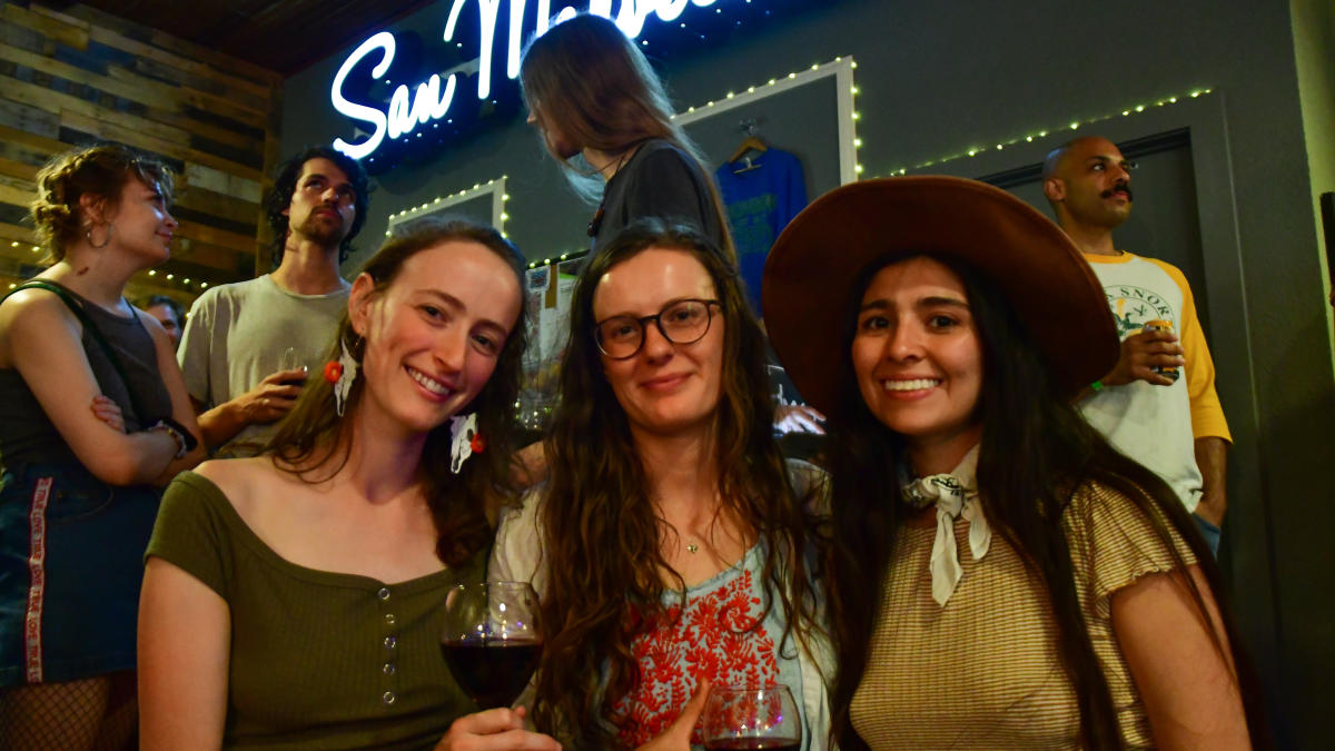 Three women at live music event