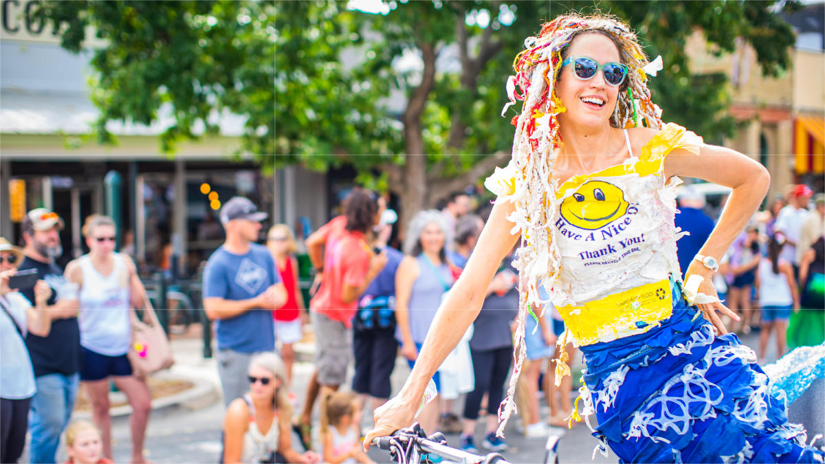 Mermaid parade participant riding a bike.