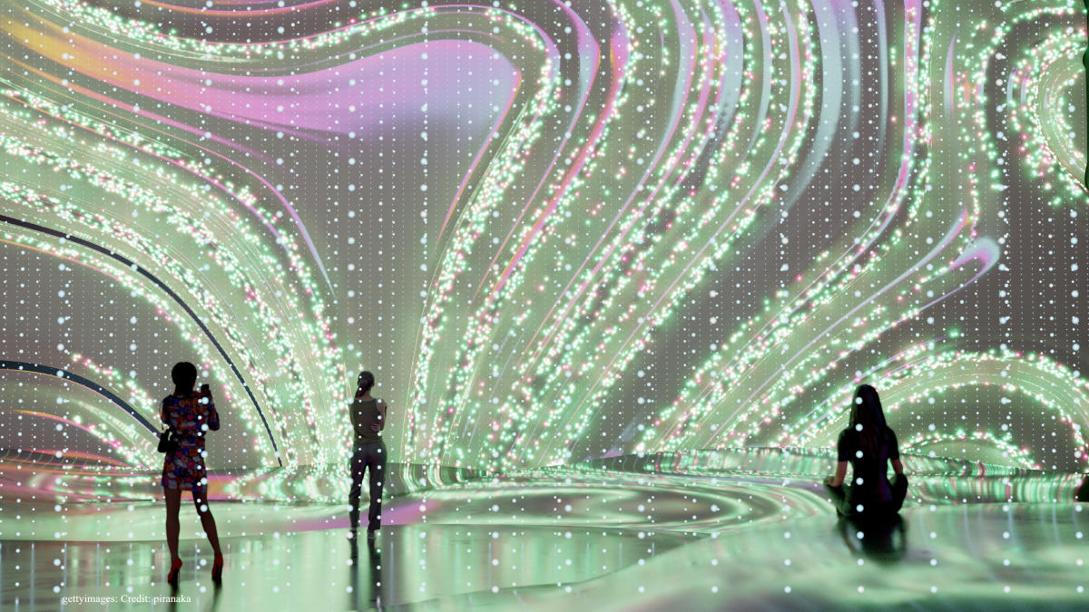 Visitors stroll among a futuristic art installation