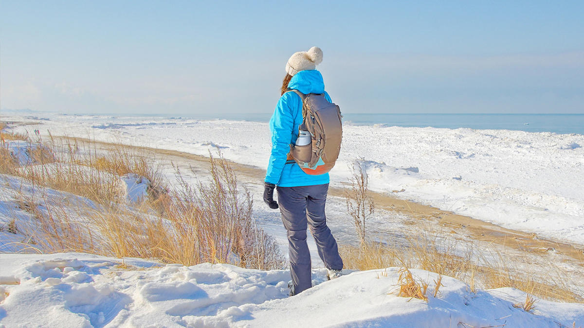 Hiker in the snow at Indiana Dunes