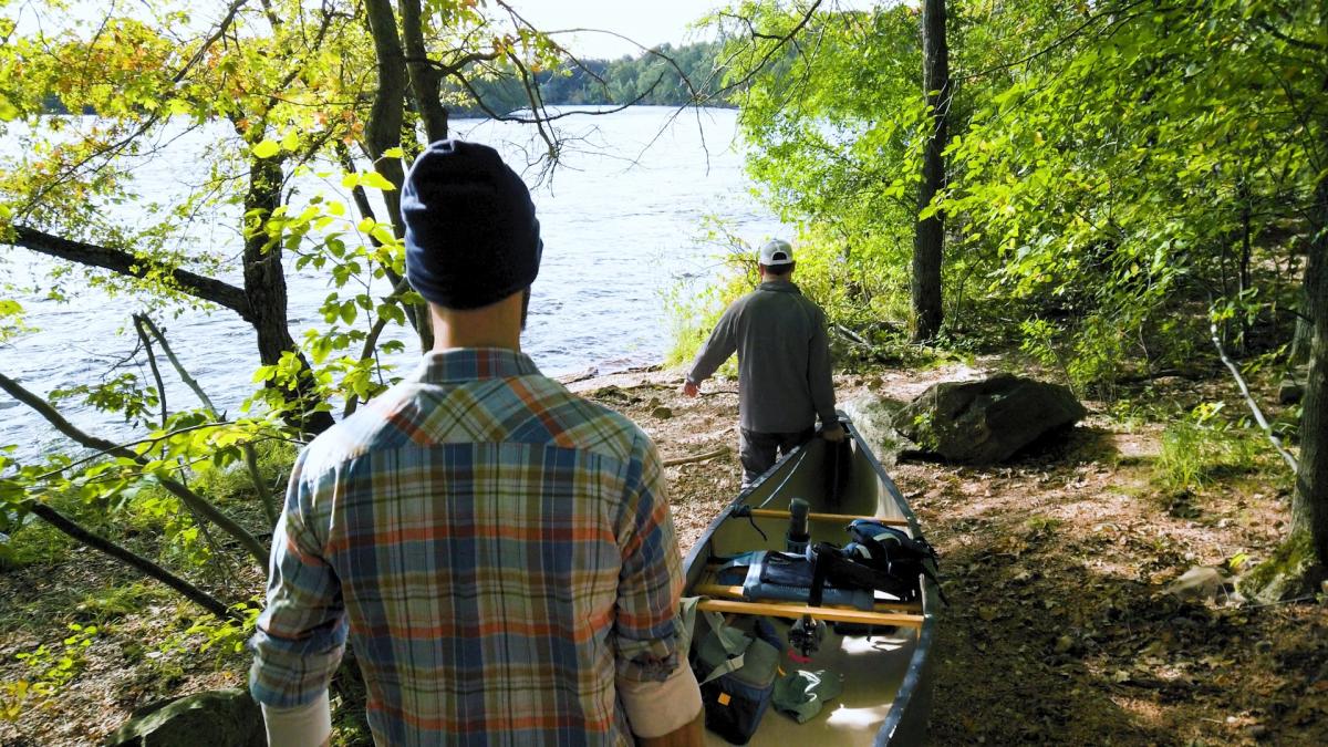 Timothy Bauer, writer for Miles Paddled, prepares to launch a canoe trip with a friend.