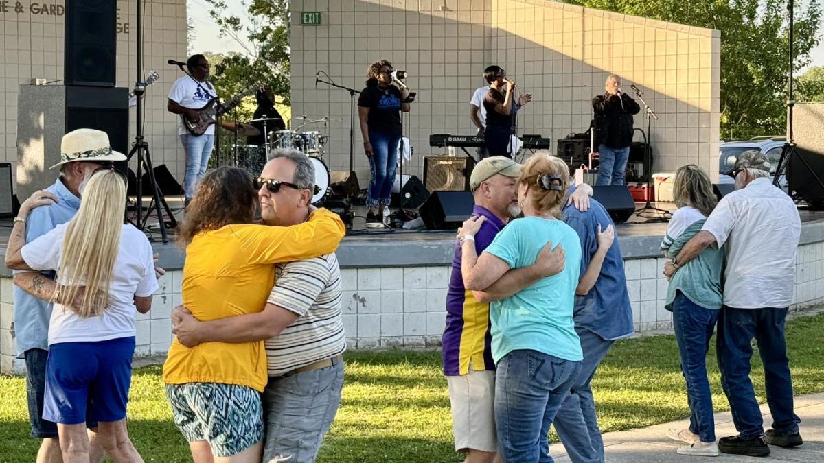 Couples dance in front of the amphitheater in Slidell's Heritage Park as a the band Soul Revival performs at a Bayou Jam concert.