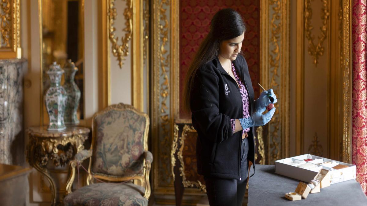 Naomi Kulasingham_Collections and House Manager at Polesden Lacey looking at a Faberge egg_ © National Trust Images_James Beck