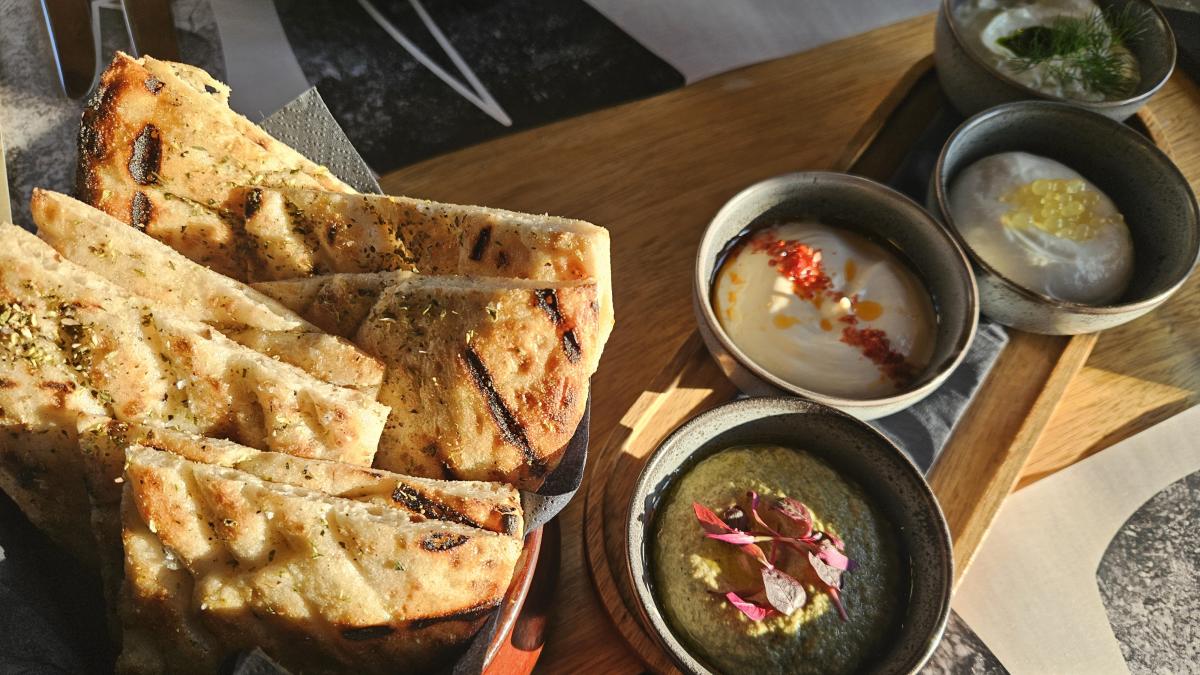 Basket of handmade pita with dips at Theion in Guildford, Surrey