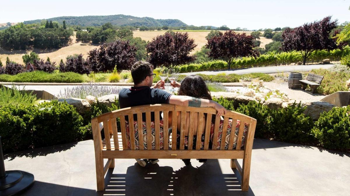 Enjoying wine on a bench in Paso Robles, CA