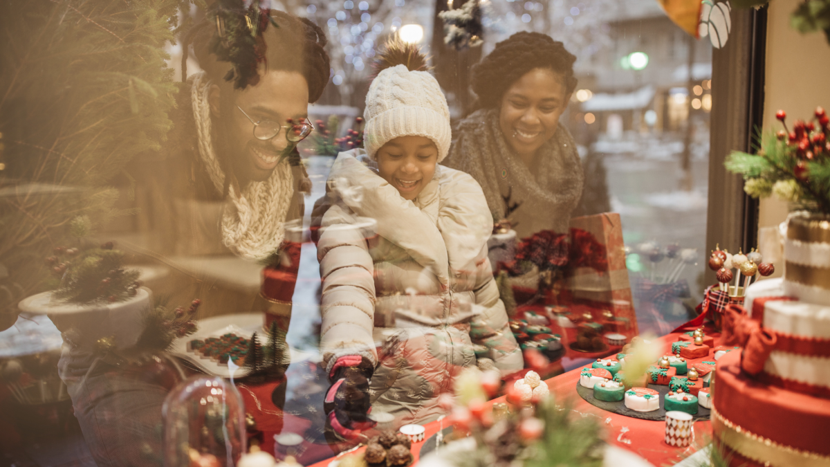 A family smiling as they window shop Christmas goodies in Vancouver, WA.