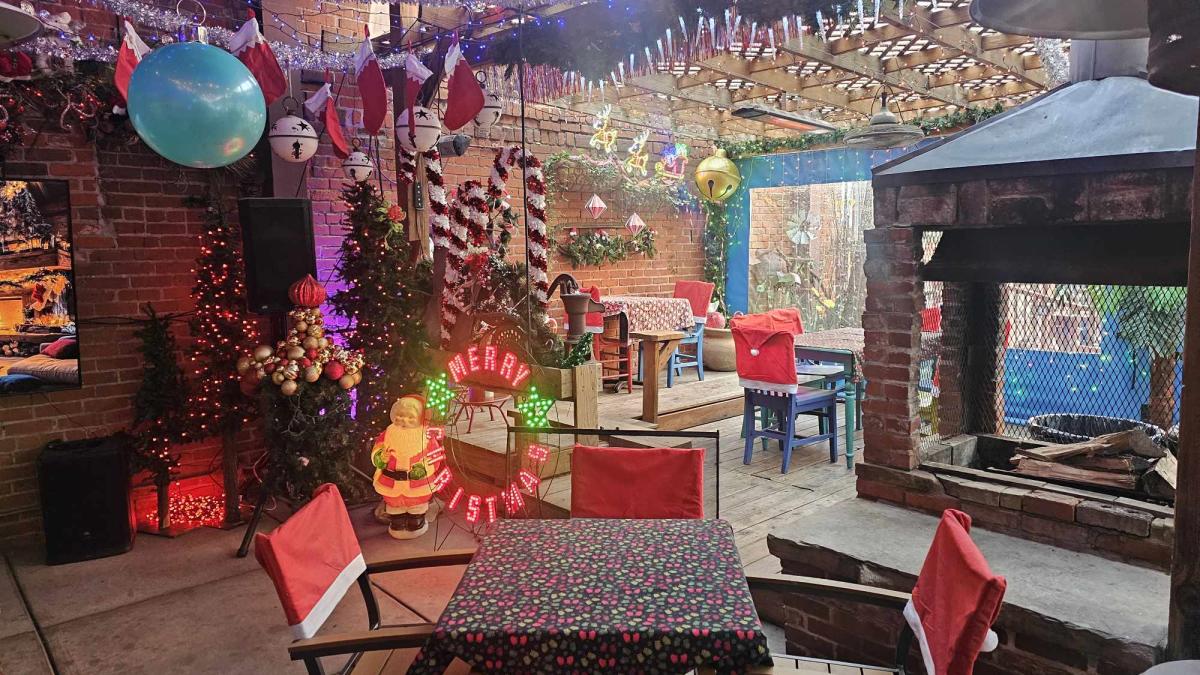 the outdoor covered patio at Public is decked out in holiday decor at Christas for its pop-up bar