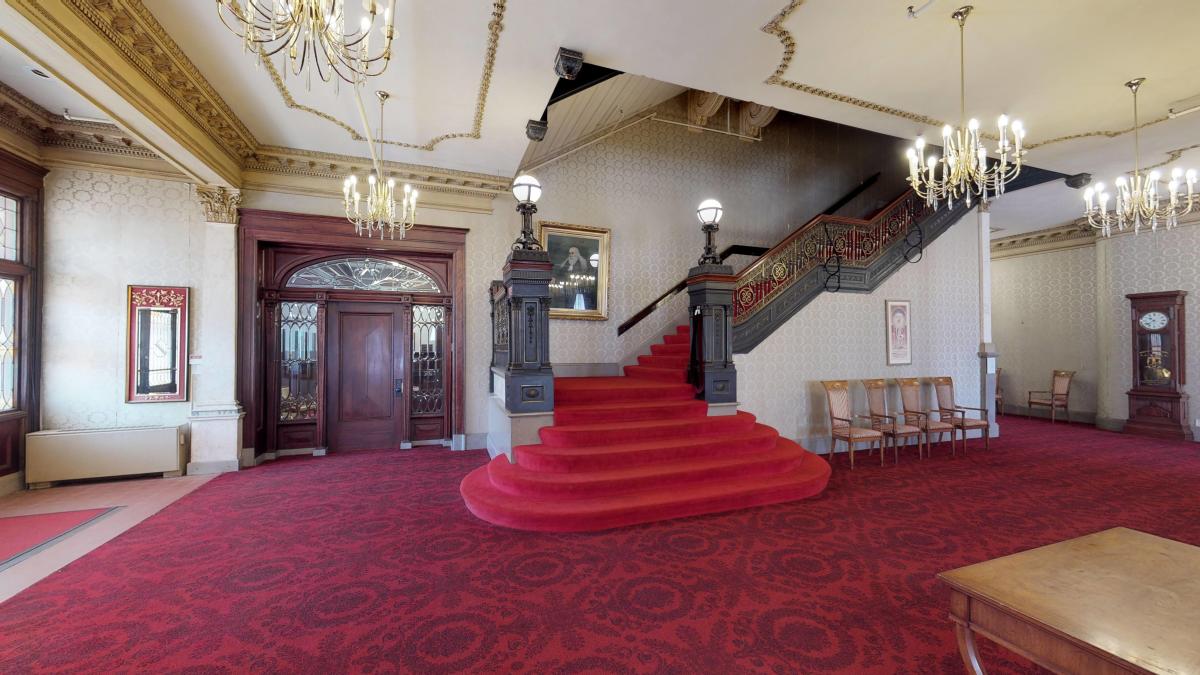 A staircase at TempleLive features bold red carpeting