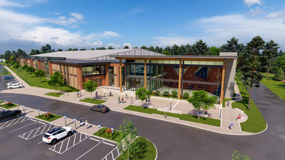 Rendering of the Greater Williamsburg Sports and Event Center. Modern sports and events center with large glass windows and wooden beams, surrounded by greenery and people engaging outside.