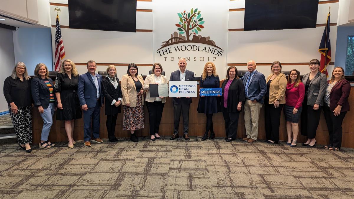 Visit The Woodlands Board and Staff stand with Global Meetings Industry Day Sign