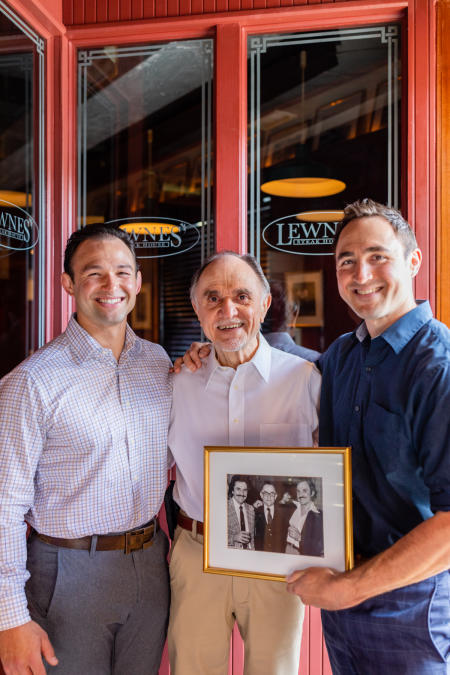 Mack, Charlie, and Sam Lewnes, with a photo of Spiro, George, and Charlie