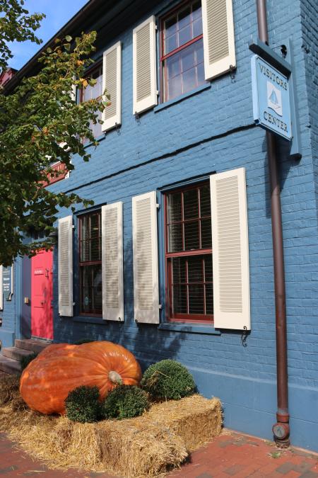 Blue building with a giant pumpkin in front