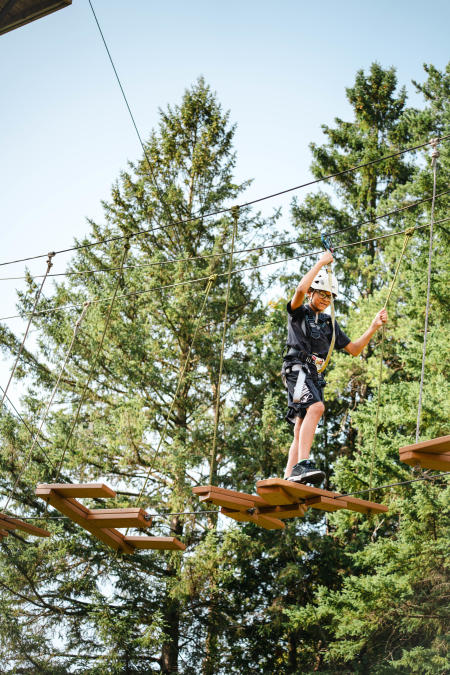 Young boy doing the ropes course at New Zoo & Adventure Park.
