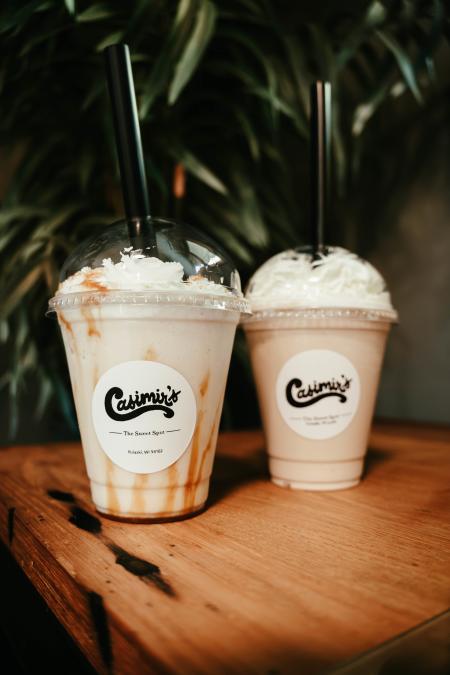 Carmel Pumpkin Frappe and Apple Pie Milkshake from Casimir's in Pulaski, Wisconsin displayed on a table.