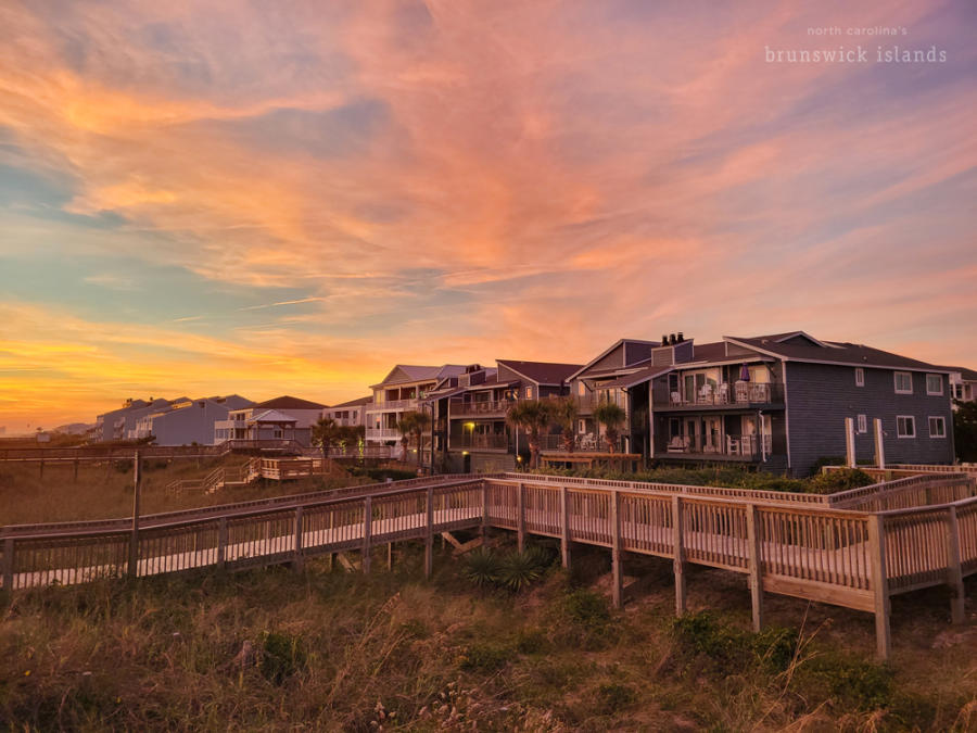 A row of houses and condos near the beach at sunset