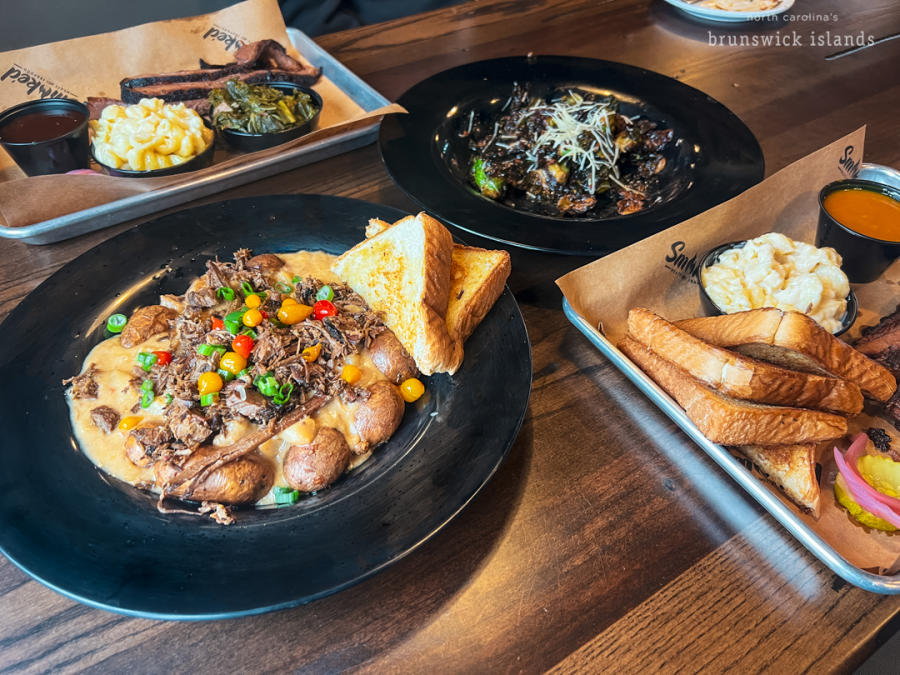 plates of barbecue and side dishes at Smoked