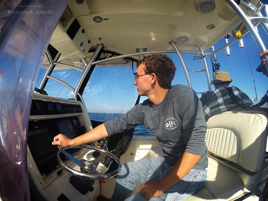 a man steering a boat