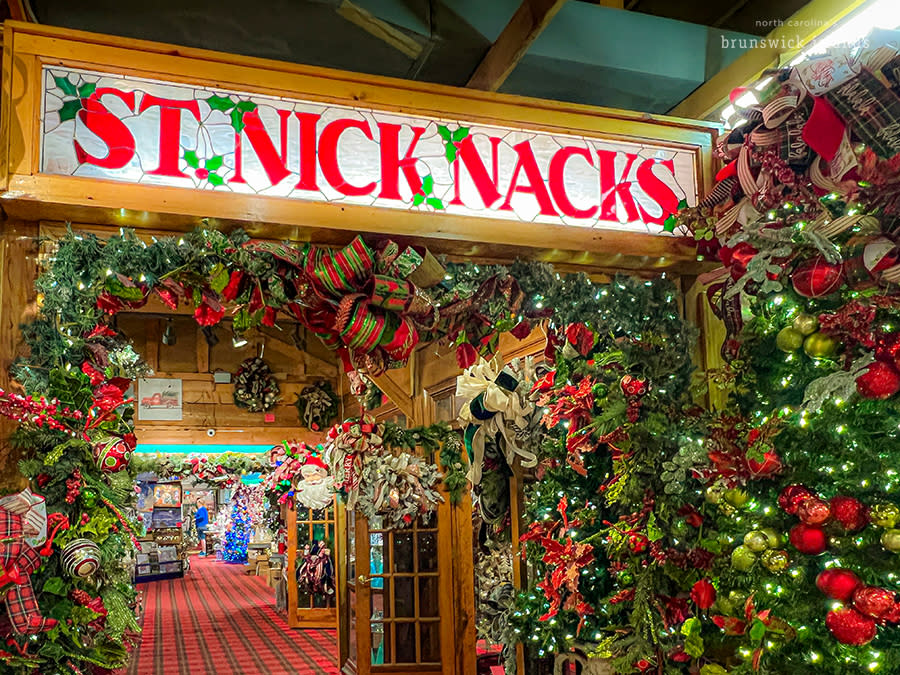 The inside of a Christmas store with lots of garland and decorations